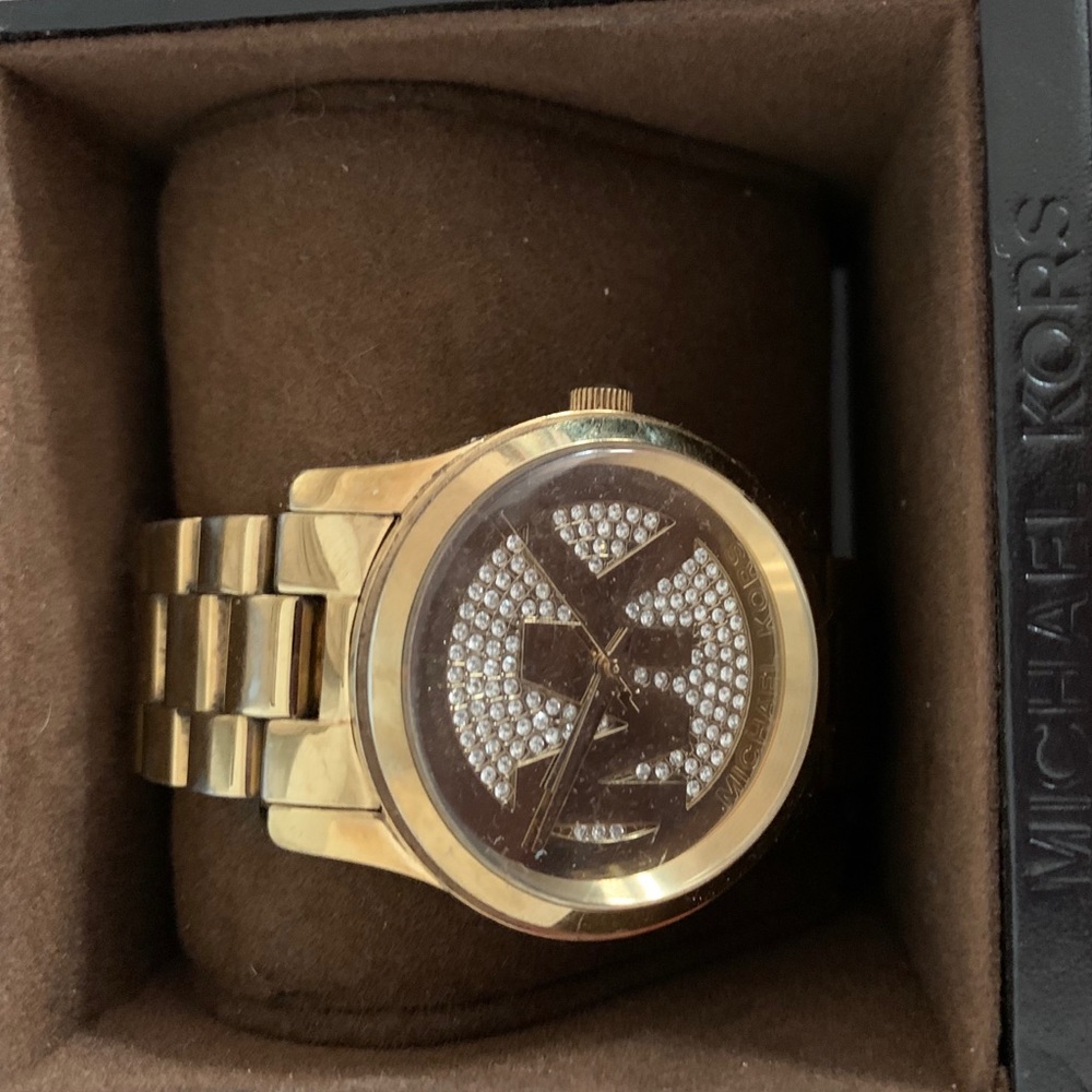 A gold MK 5706 watch
